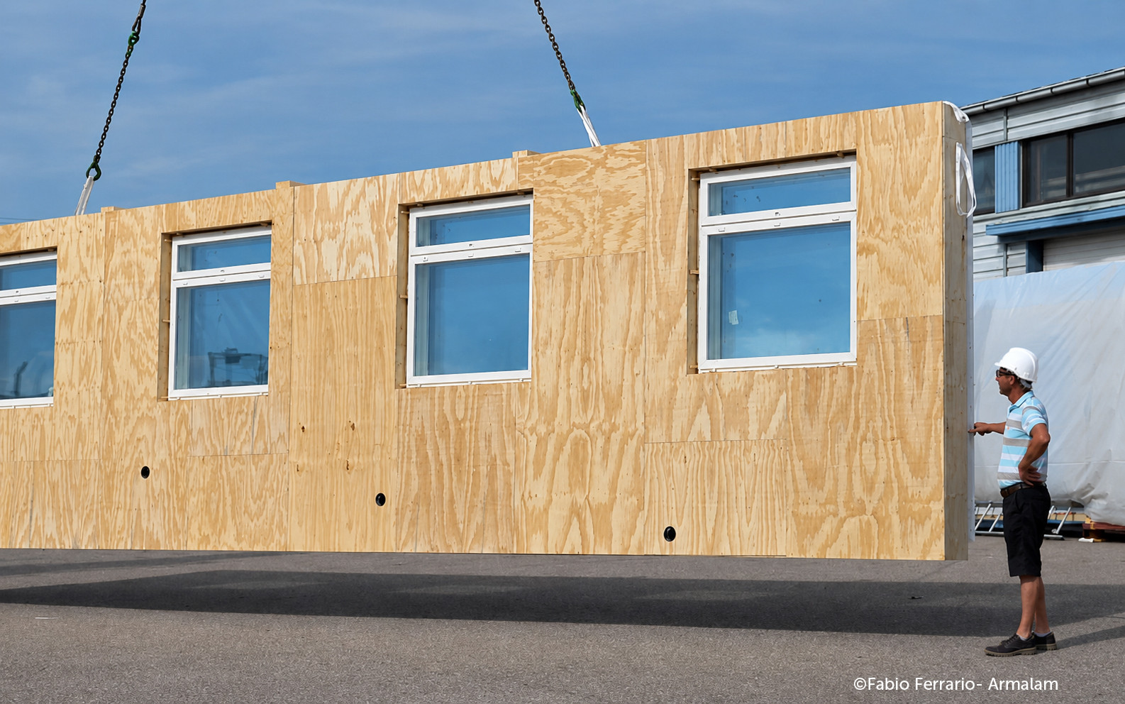 Prefabricated timber facade module with windows for off-site retrofit installation on existing buildings